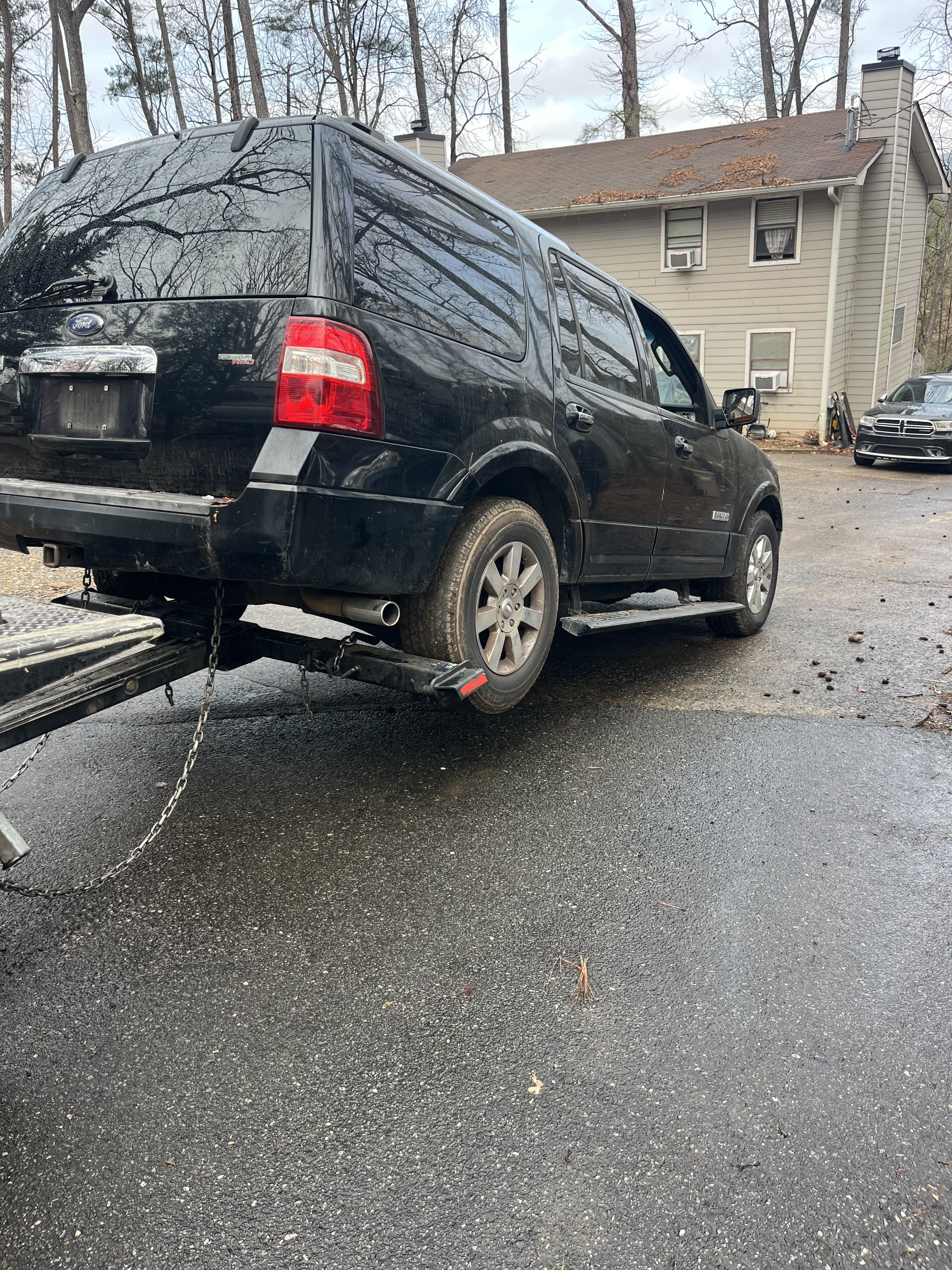Ford Expedition loaded on flatbed tow truck Atlanta GA — free junk car towing RidOfMyCar