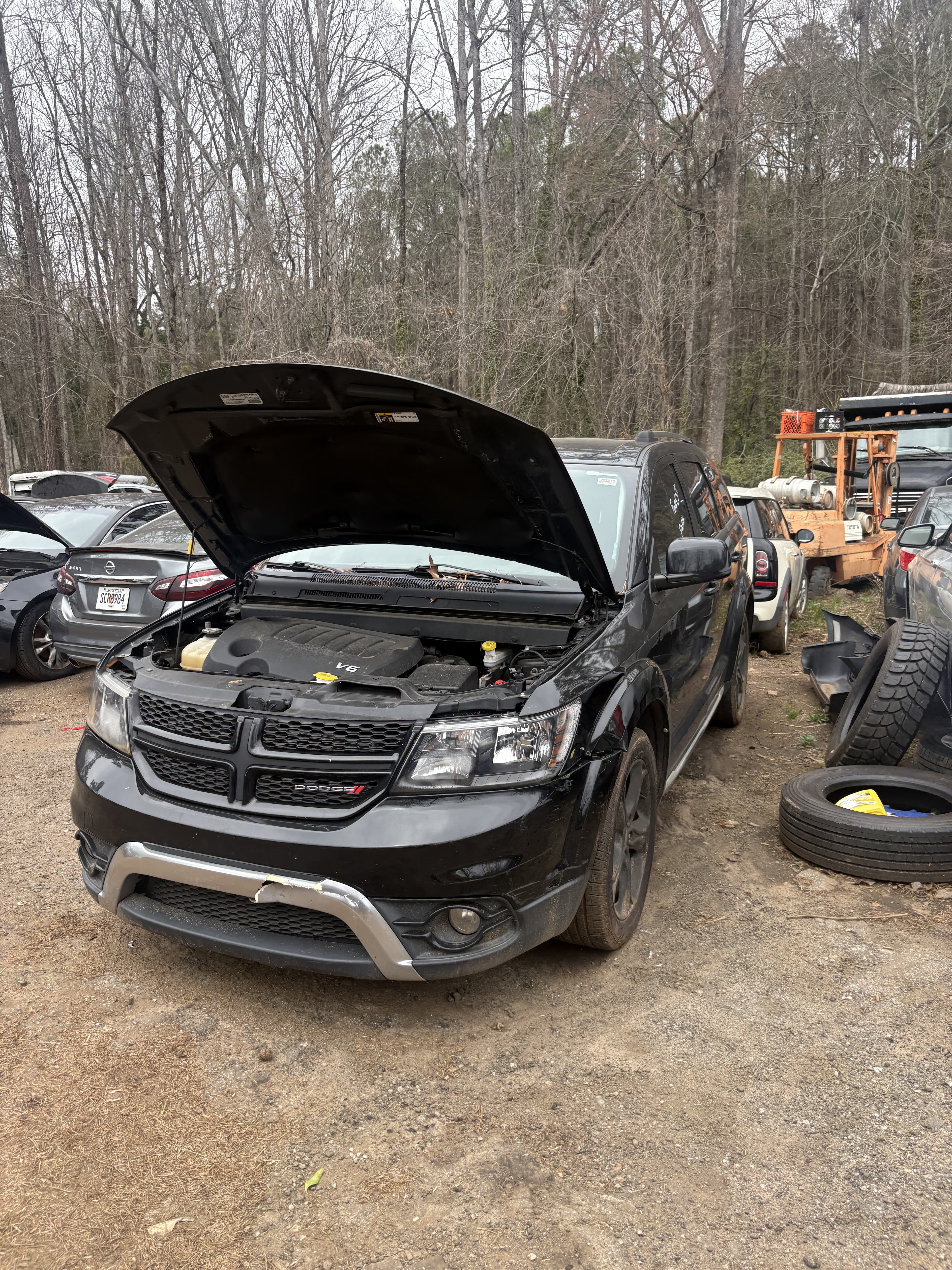 Dodge Journey with hood open purchased for cash at junk car lot Atlanta GA